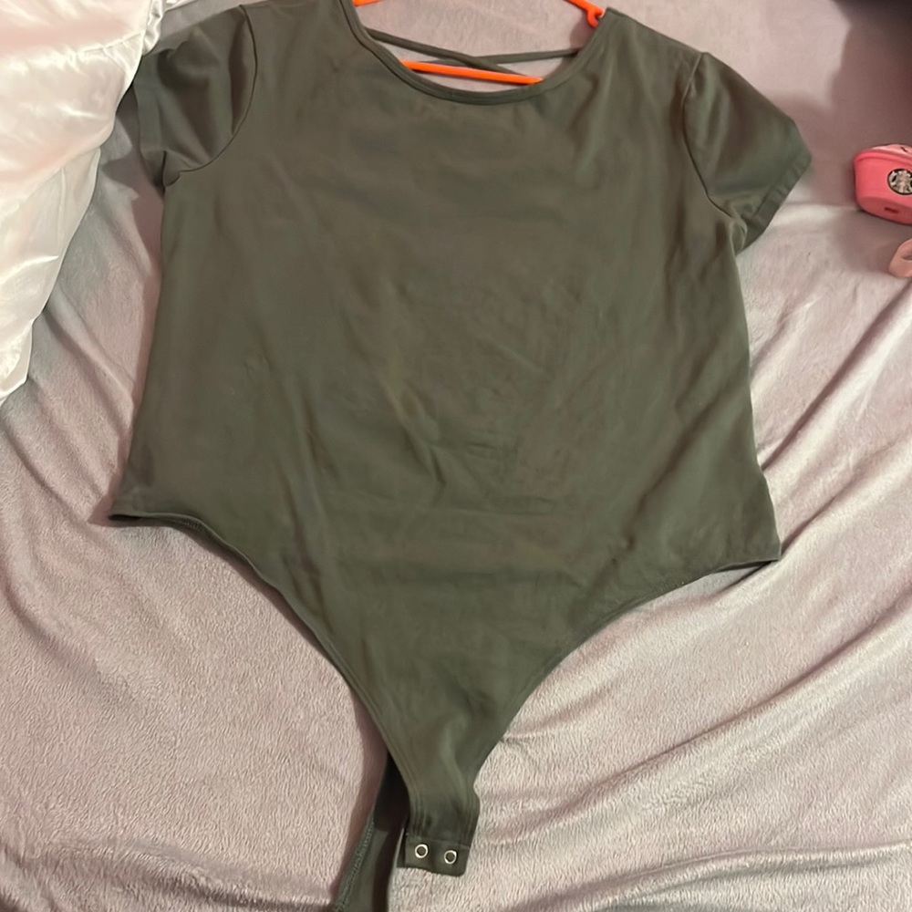 A green bodysuit barely worn
